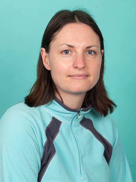 headshot of Kim in a blue top